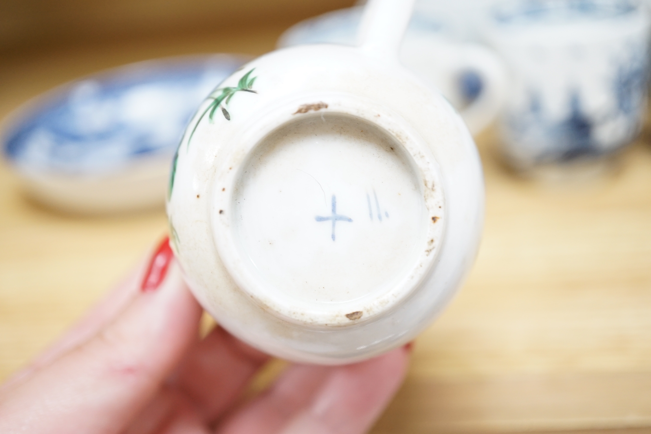 Seven various English porcelain coffee cups, including two Bristol enamelled with green floral sprays, two Bow painted in underglaze blue with a bird in a Chinese garden, and three Worcester/Bow in underglaze blue.